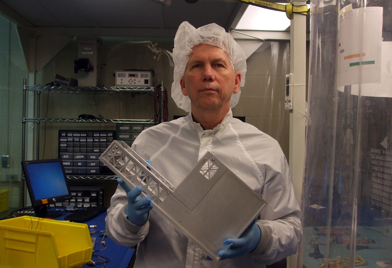 NSS Director and Team Member Dean Larson holds the Cislunar Explorers Spacecraft in the Cornell University Clean Room 