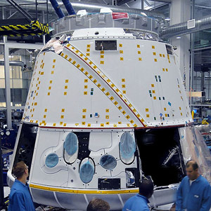 Technicians work on the Dragon spacecraft in SpaceX facility in Hawthorne, CA