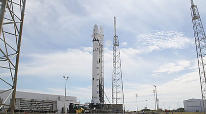 The full flight-ready Falcon 9 launch vehicle with Dragon qualification spacecraft raised to vertical on the launch pad at SLC-40, Cape Canaveral, Florida. Credit: SpaceX.