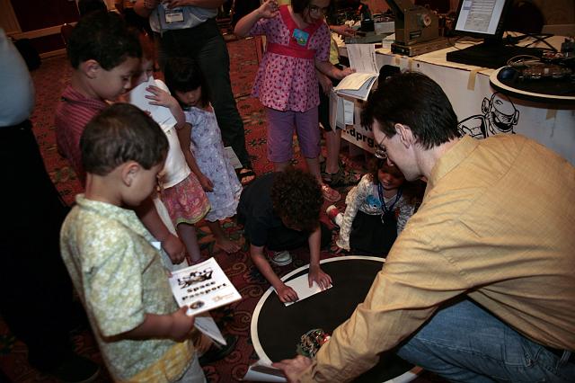 Kids play with robots at the Robotics Group exhibit at the International Space Development Conference  