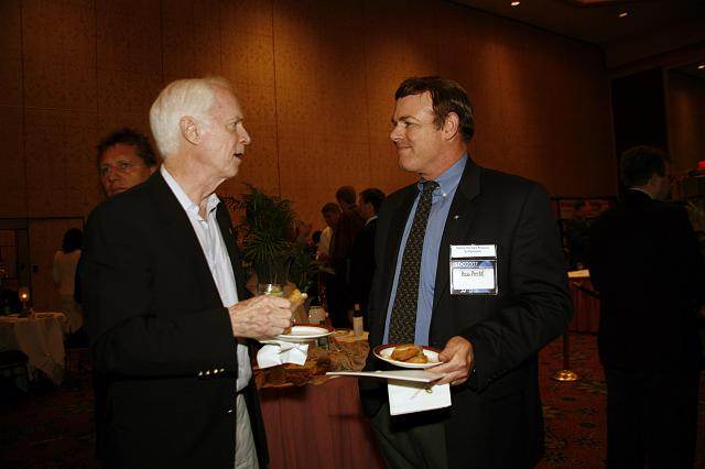 Apollo Astronaut and B612 Foundation founder Rusty Schweickart talks with Russ Prechtl at the Space Venture Finance Symposium reception, a part of the International Space Development Conference