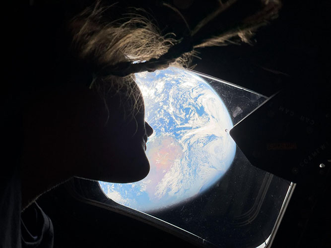 Christina Koch looking at Earth